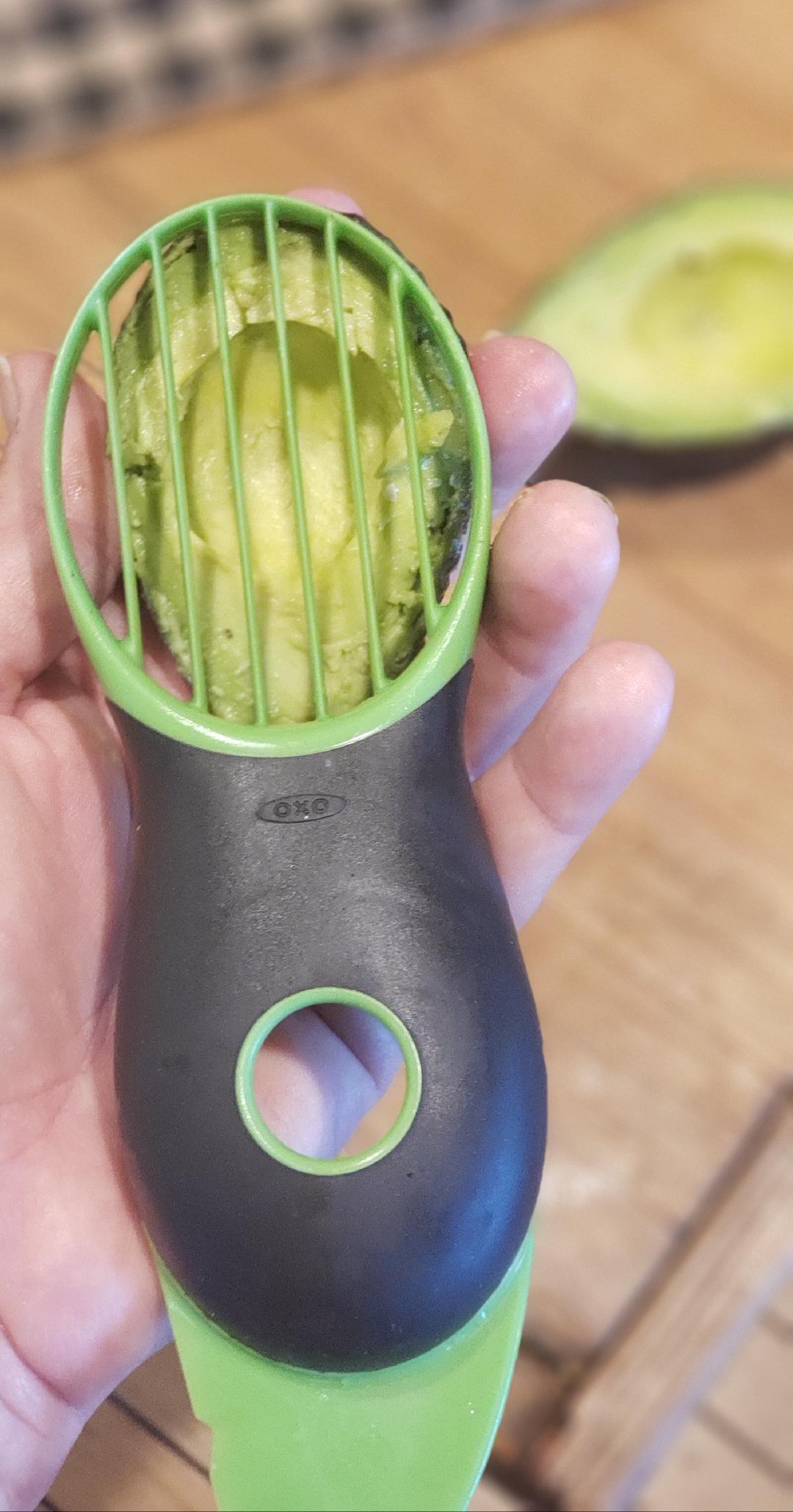 kitchen avocado slicer tool slicing an avocado