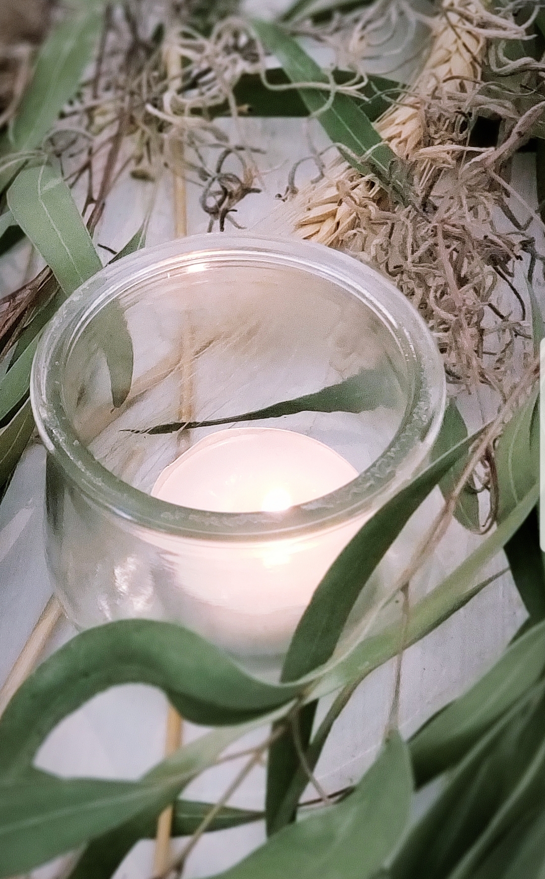 glass votive candle on nature inspired table setting