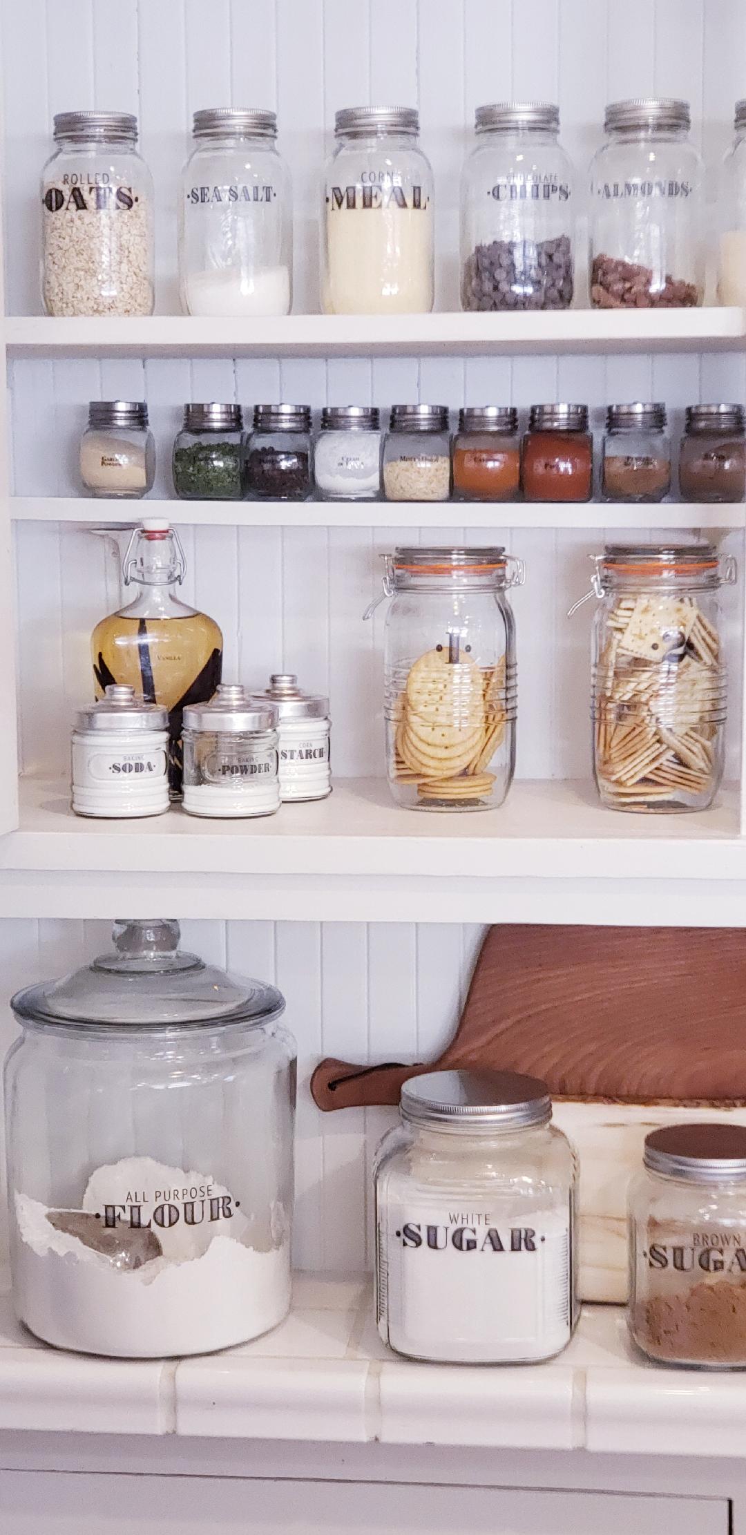 farmhouse pantry organized with clear jars and labels including baking items