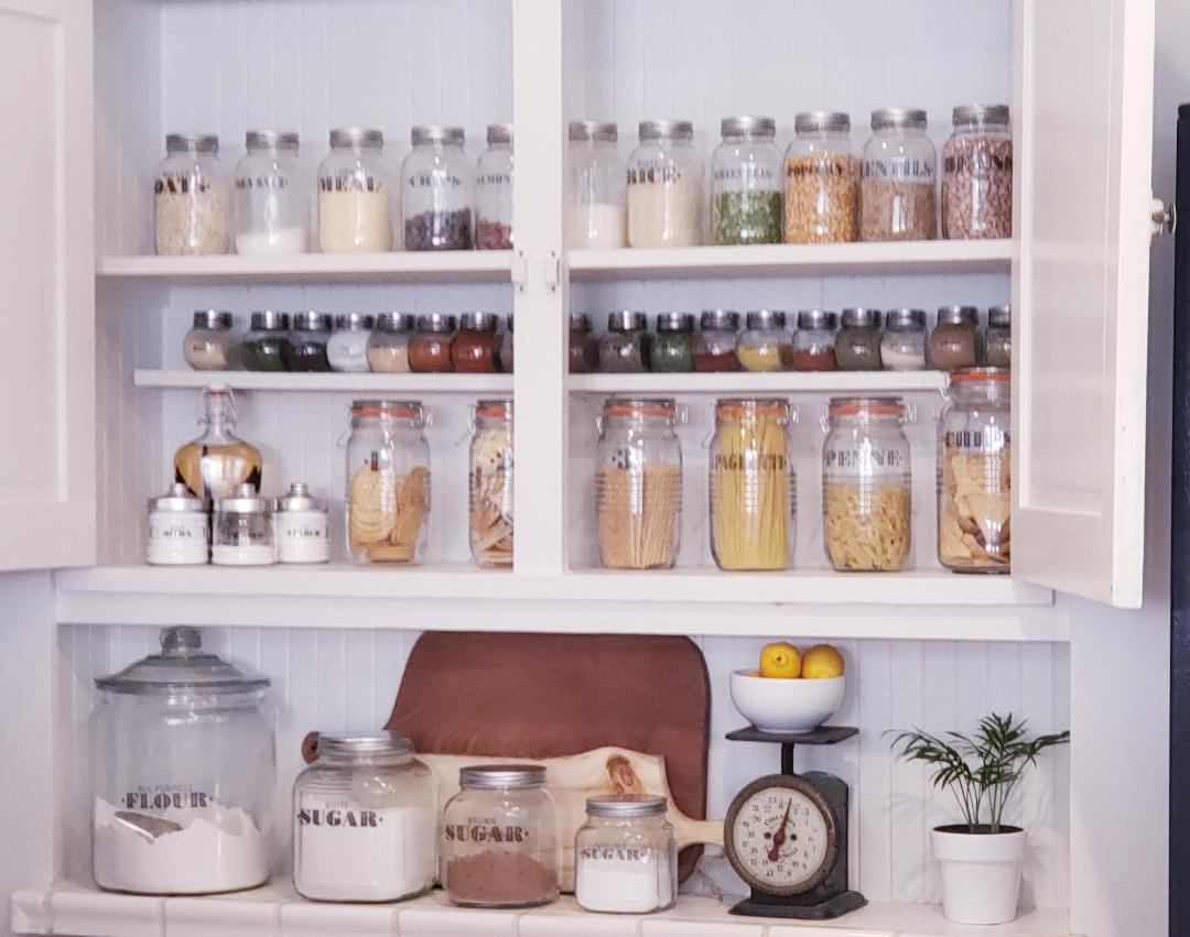 open door pantry with labeled jars 
