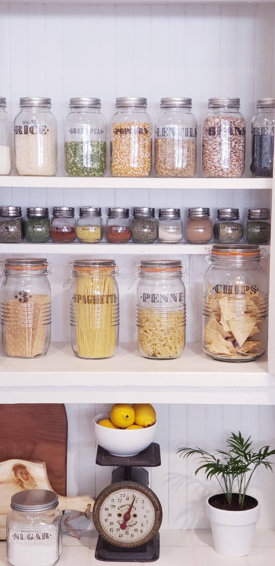 farmhouse pantry organized with clear jars and labels